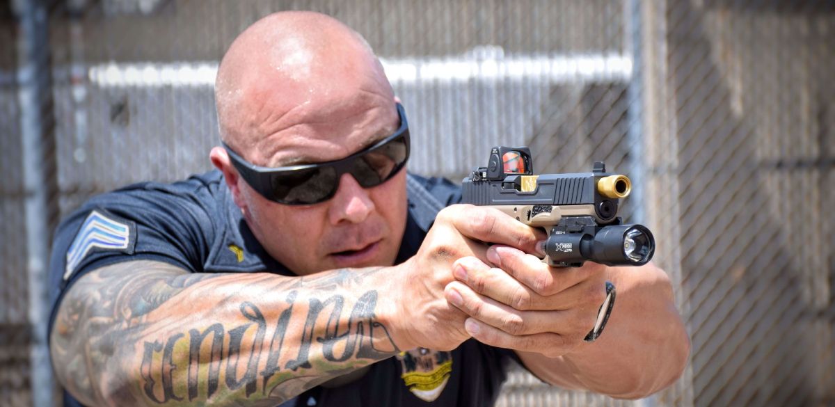Officer aiming down the barrel of custom pistol