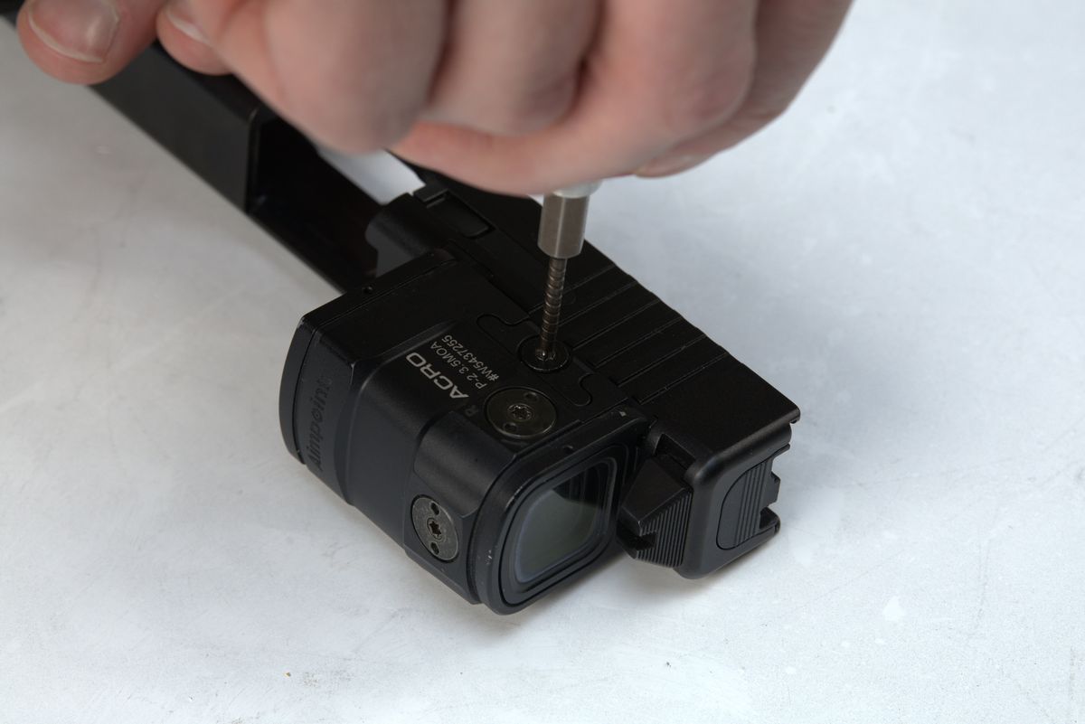 Aimpoint ACRO being mounted to plate on Glock slide