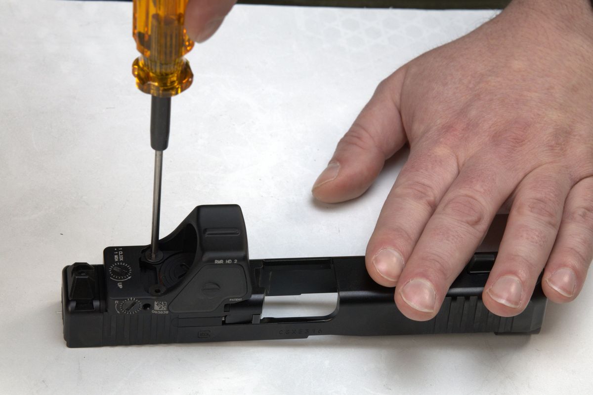 Securing RMR optic with screwdriver on DCA slide